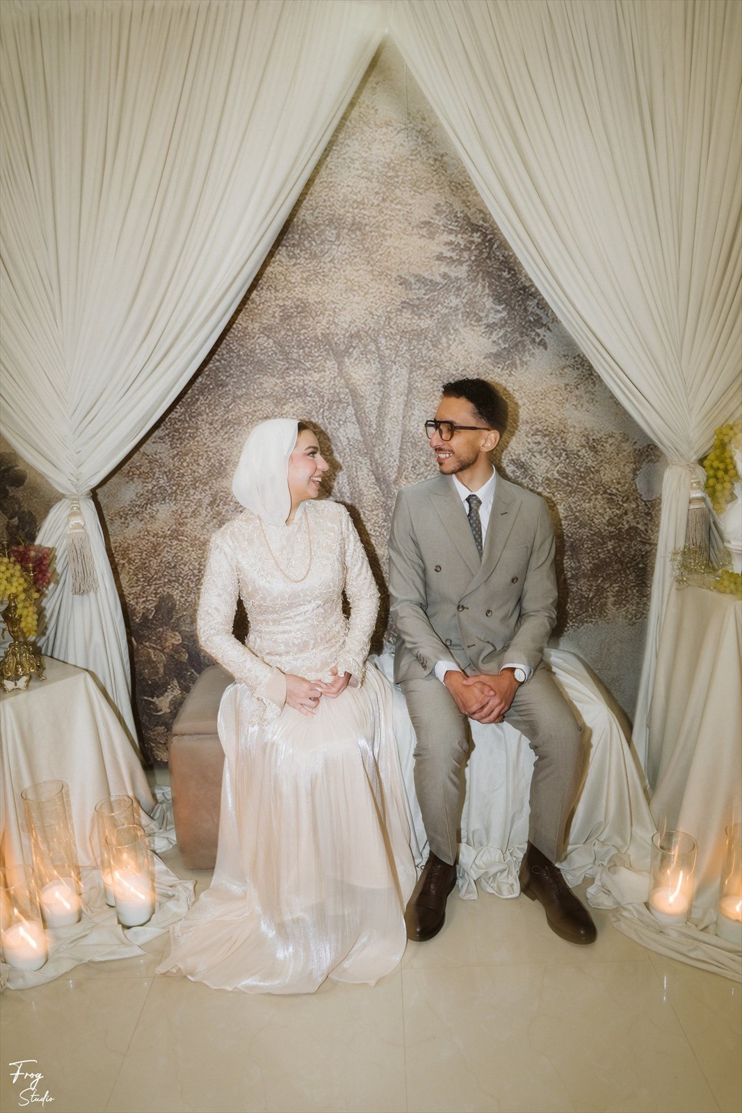 Reem and Mohamed seated together on the engagement bench, looking at each other and laughing