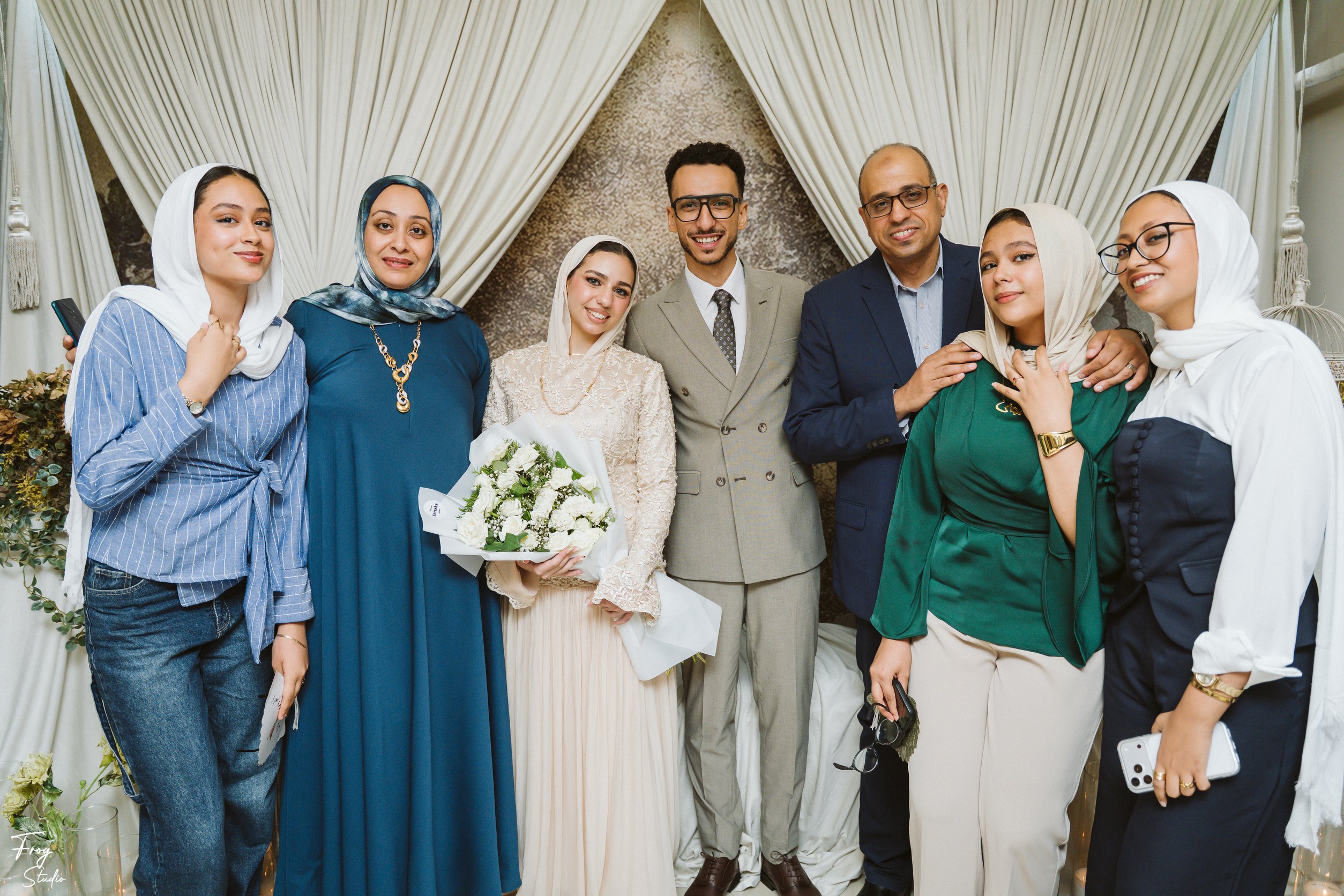A wide group photograph of the family gathered around Mohamed and Reem