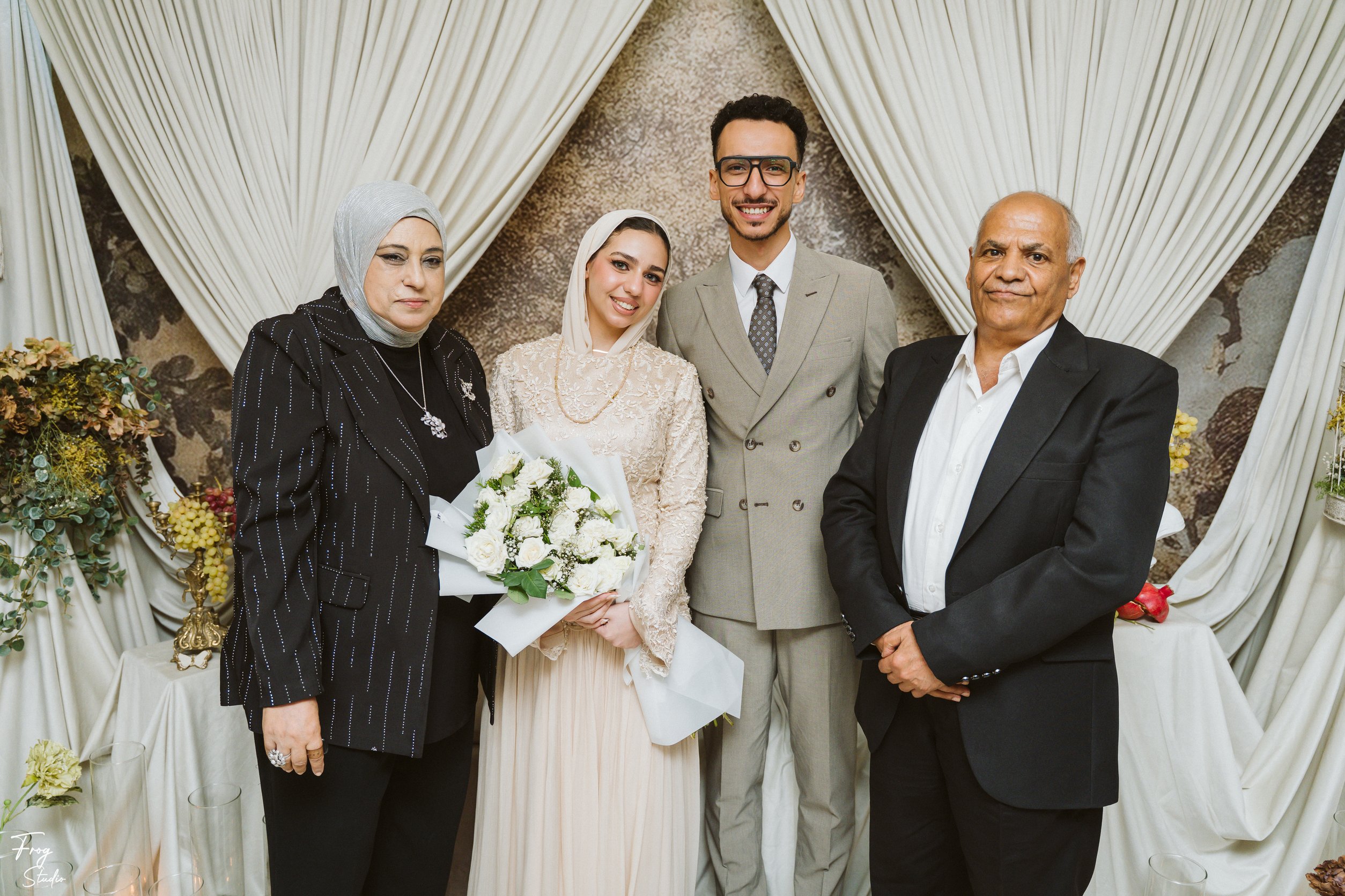 Mohamed and Reem with an older couple at the engagement celebration