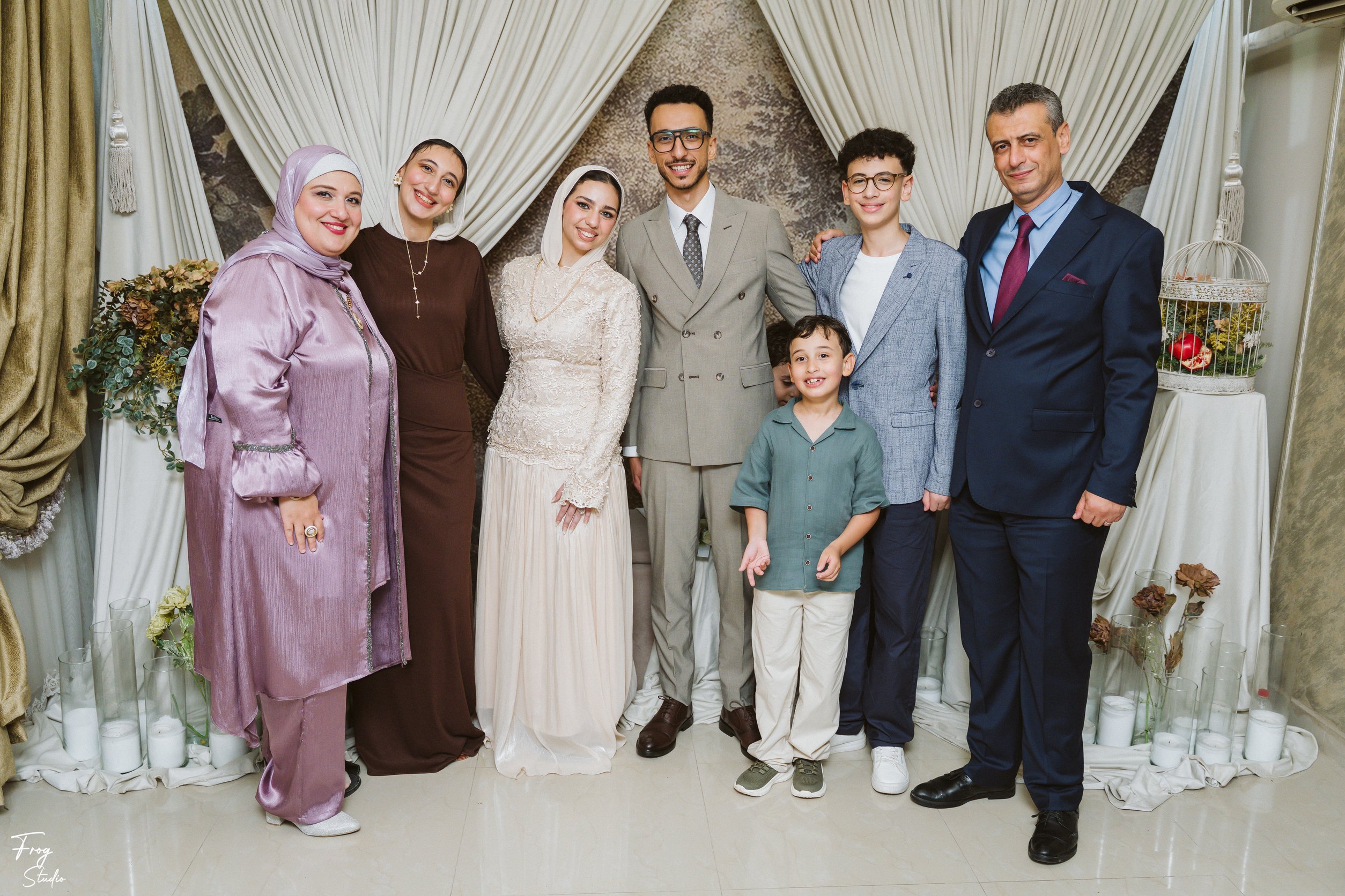Seven family members with Mohamed and Reem, including a lady in a lilac abaya