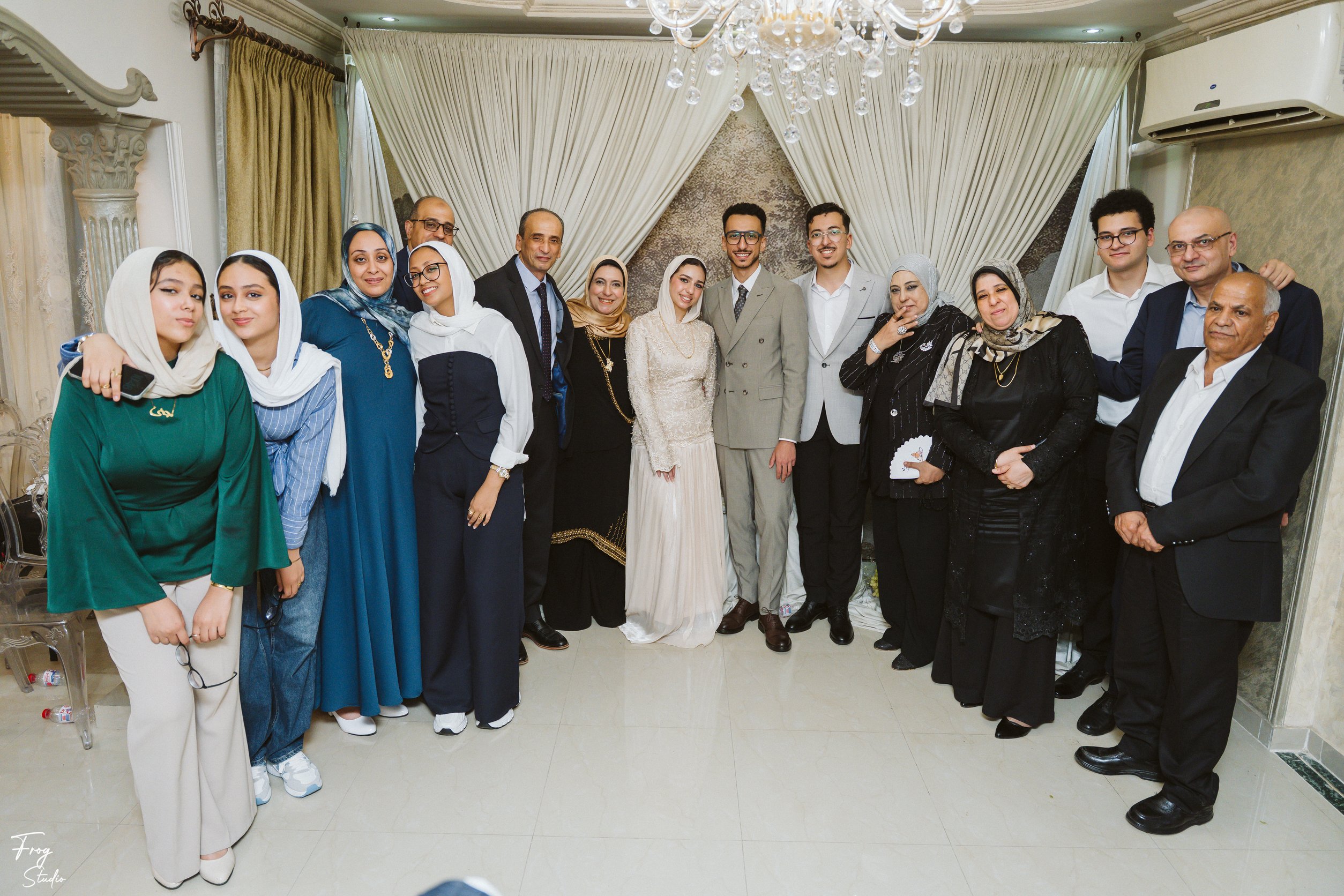 A very large group of family members of all ages gathered around Mohamed and Reem