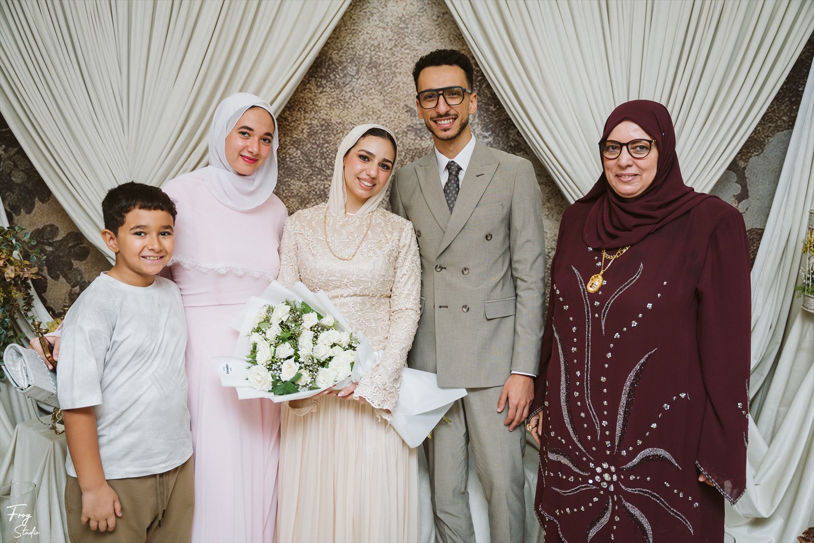 Reem and Mohamed photographed with family at the engagement party