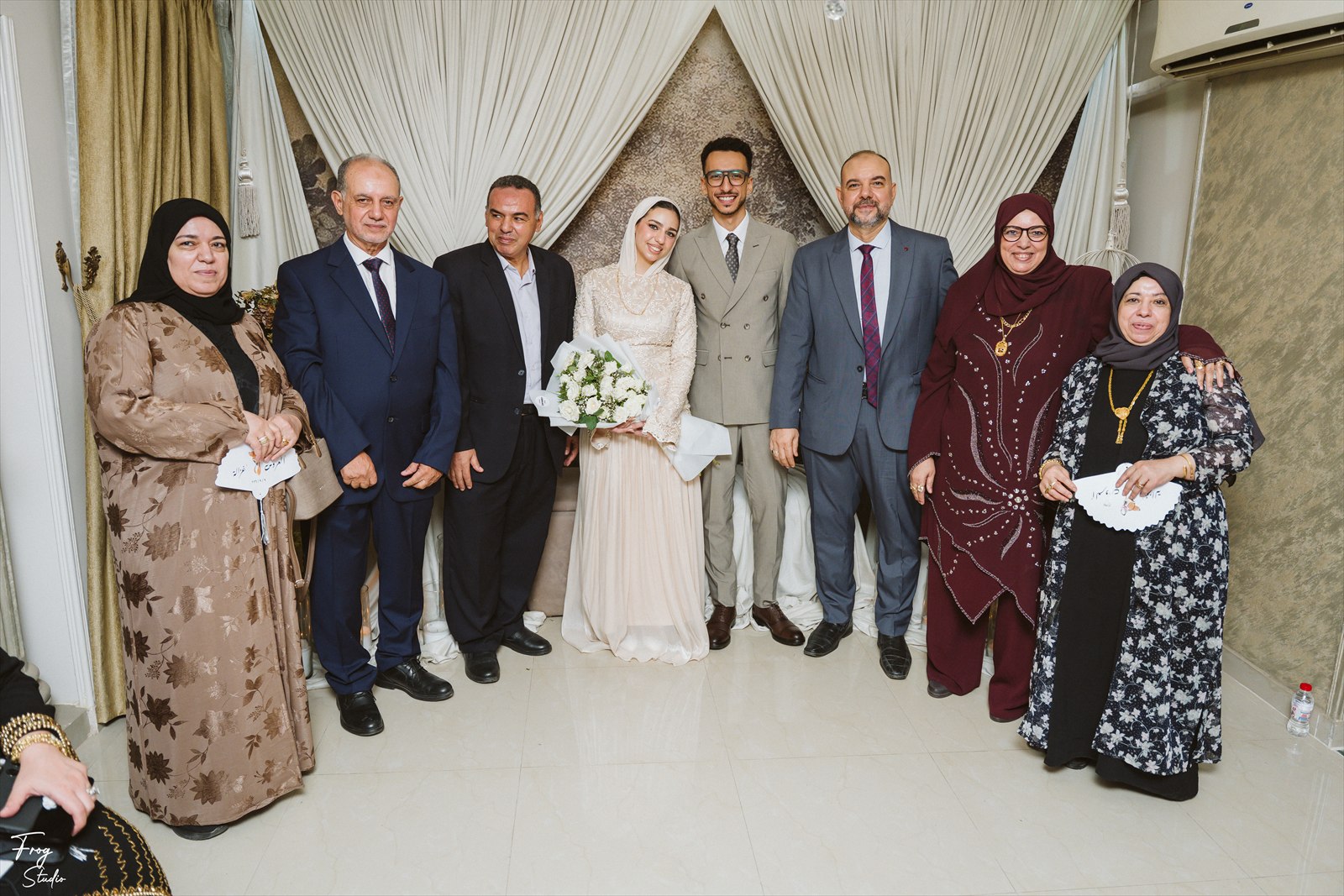 A large group of family members posing together with Reem and Mohamed