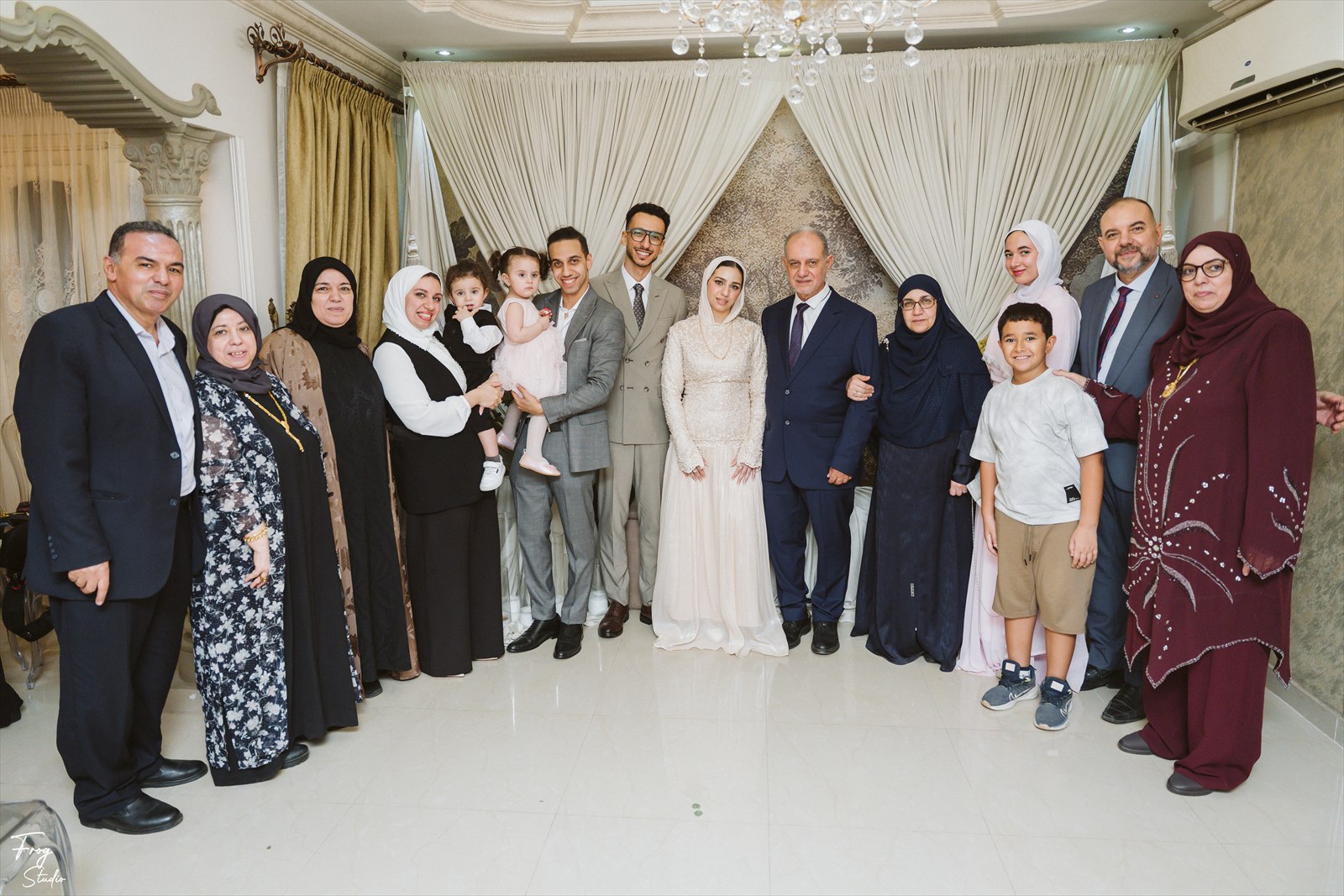 A large family group photograph with Reem and Mohamed at the centre