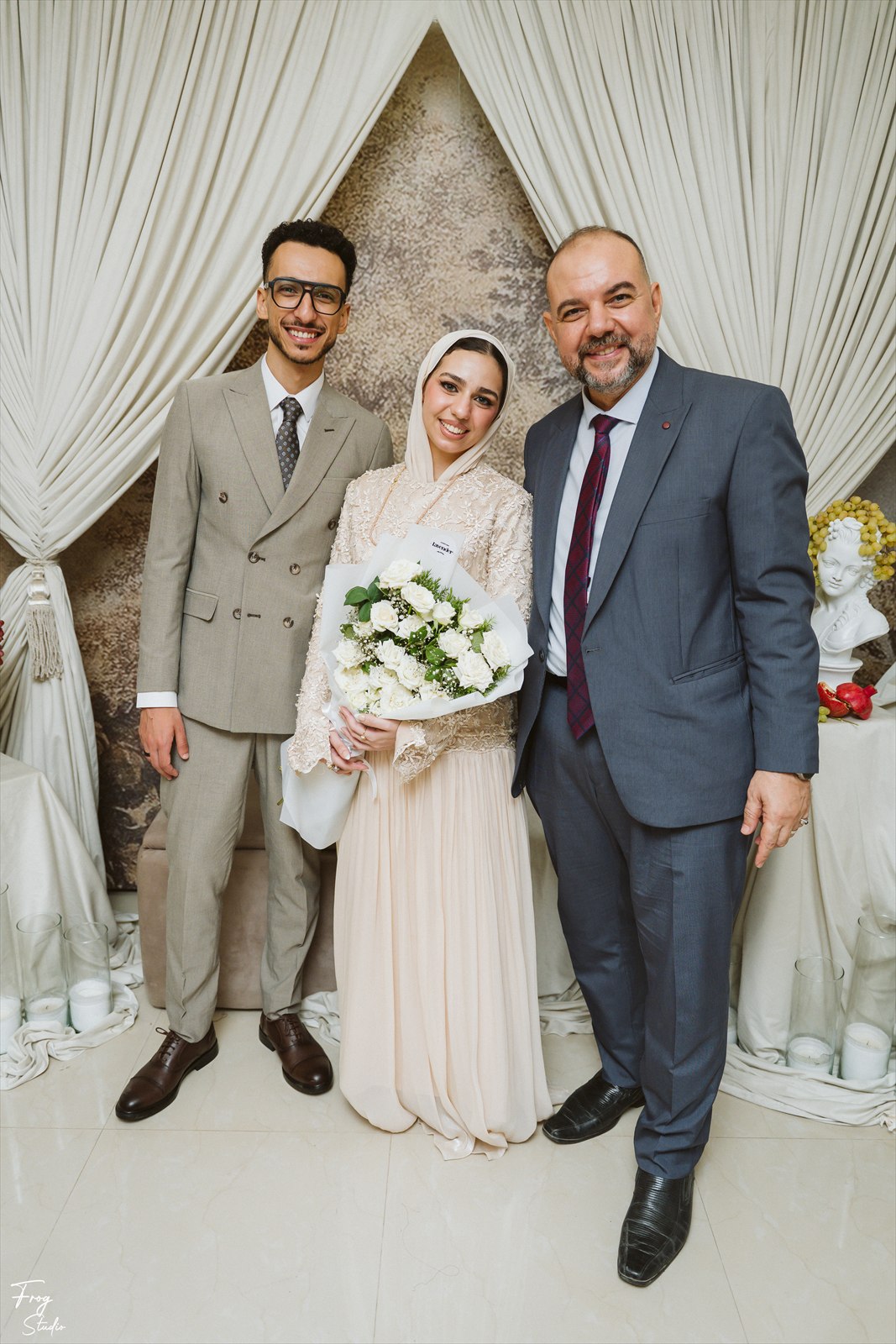 Reem and Mohamed photographed with family members either side of them