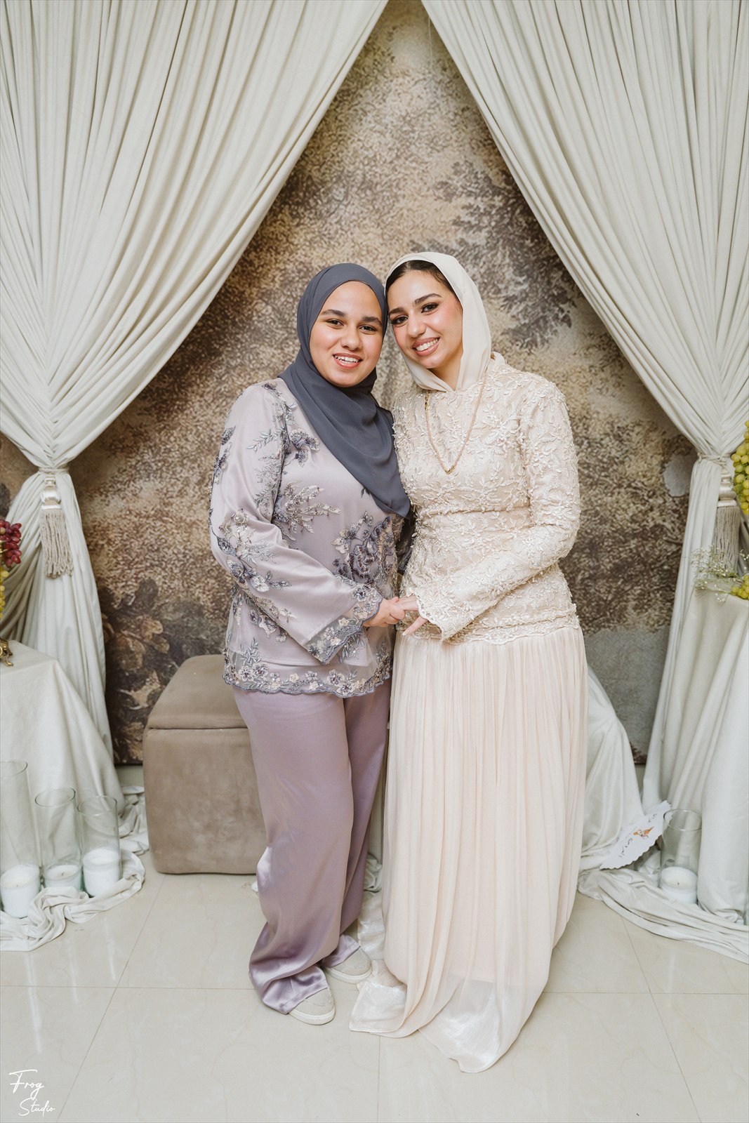 Reem and Mohamed standing with a family member at the engagement party