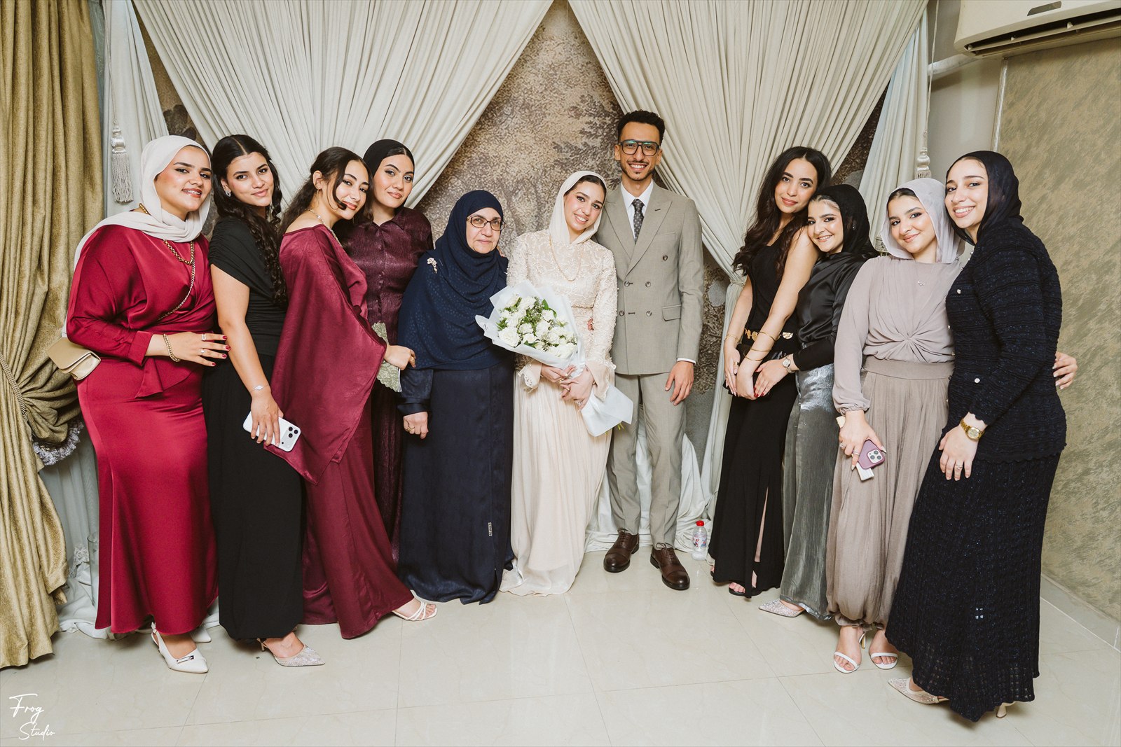 A wide group photograph of the family with Reem and Mohamed